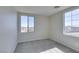 Cozy bedroom with plush carpeting, neutral paint, white trim, and a view of the neighborhood at 9102 Brilliant Prairie Ct, Las Vegas, NV 89149