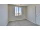 Bedroom featuring plush carpeting, neutral paint, white trim, a closet, and a large window at 9102 Brilliant Prairie Ct, Las Vegas, NV 89149