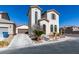 Two-story home with arched windows and desert landscaping at 9102 Brilliant Prairie Ct, Las Vegas, NV 89149