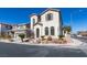 Two-story home with arched windows and desert landscaping at 9102 Brilliant Prairie Ct, Las Vegas, NV 89149