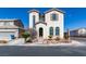 Two-story home featuring arched windows and desert landscaping at 9102 Brilliant Prairie Ct, Las Vegas, NV 89149