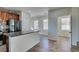 Open kitchen and dining area featuring stainless steel appliances, granite counters, and light tile flooring at 9102 Brilliant Prairie Ct, Las Vegas, NV 89149