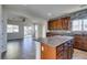 Open kitchen with cherry cabinets, granite countertops, and views to the living area at 9102 Brilliant Prairie Ct, Las Vegas, NV 89149