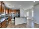 Charming kitchen with wooden cabinets, mosaic backsplash, stainless appliances, and a granite countertop island at 9102 Brilliant Prairie Ct, Las Vegas, NV 89149