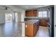 Kitchen with granite countertops, wood cabinets, and tile floors open to the living area and backyard at 9102 Brilliant Prairie Ct, Las Vegas, NV 89149