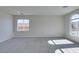 Large, carpeted living room with arched window at 9102 Brilliant Prairie Ct, Las Vegas, NV 89149