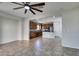 Bright living room featuring tile flooring, ceiling fan, and open access to the kitchen at 9102 Brilliant Prairie Ct, Las Vegas, NV 89149