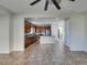 Bright living room featuring tile flooring, ceiling fan, and open access to the kitchen at 9102 Brilliant Prairie Ct, Las Vegas, NV 89149