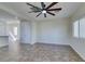 Bright living room featuring tile flooring, ceiling fan, and open access to another room at 9102 Brilliant Prairie Ct, Las Vegas, NV 89149