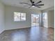 Bright living room featuring tile flooring, ceiling fan, and sliding door access to the backyard at 9102 Brilliant Prairie Ct, Las Vegas, NV 89149