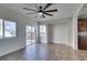 Bright living room featuring tile flooring, ceiling fan, and sliding door access to the backyard at 9102 Brilliant Prairie Ct, Las Vegas, NV 89149