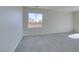 Expansive, freshly carpeted living room with large window at 9102 Brilliant Prairie Ct, Las Vegas, NV 89149