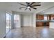 Bright living room featuring tile flooring, ceiling fan, and open access to the kitchen at 9102 Brilliant Prairie Ct, Las Vegas, NV 89149