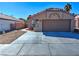 Charming single-story home featuring a well-maintained front yard and a two-car garage at 951 Carnival Ave, Las Vegas, NV 89123