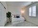 Bright bedroom with a cozy daybed, stylish shutters, and a decorative house plant at 712 N Water St, Henderson, NV 89015