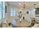 Charming dining space features a round table, elegant chandelier, and shuttered windows at 712 N Water St, Henderson, NV 89015