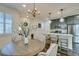 Bright dining space with a round wooden table, decorative chandelier, and modern kitchen view at 712 N Water St, Henderson, NV 89015