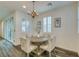 Cozy dining area with a round table, chandelier, and natural light from the sliding doors at , Henderson, NV 89015