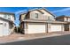 Contemporary two-story townhome with a brick-paved driveway leading to the two car garage at 712 N Water St, Henderson, NV 89015