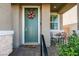 Charming front door with a wreath, cozy seating, and welcoming decor at , Henderson, NV 89015