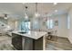 Open-concept kitchen featuring a central island with seating and views into the dining and living areas at , Henderson, NV 89015