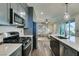 Contemporary kitchen with stainless steel appliances, a center island, and an open view to the living space at , Henderson, NV 89015