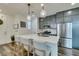 Stylish kitchen with stainless steel appliances, a central island with seating, and modern lighting at 712 N Water St, Henderson, NV 89015