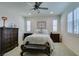 Bright main bedroom with a ceiling fan, lots of natural light and classic wood furniture at , Henderson, NV 89015