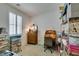 Functional home office featuring vintage furniture, bright windows, and ample storage shelves at 712 N Water St, Henderson, NV 89015