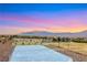 Backyard view showcasing recreational park and mountain views at sunset at 10184 Fire Skye Ave, Las Vegas, NV 89166