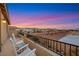 Balcony with rocking chairs overlooking the desert landscape at sunset at 10184 Fire Skye Ave, Las Vegas, NV 89166