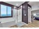 Elegant bathroom with a soaking tub, glass-enclosed shower, window view, and modern fixtures at 10184 Fire Skye Ave, Las Vegas, NV 89166