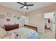 Bright bedroom features pink walls, wood floors, and a walk in closet at 10184 Fire Skye Ave, Las Vegas, NV 89166