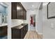 Hallway with wood floors, dark cabinets and decor at 10184 Fire Skye Ave, Las Vegas, NV 89166