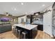 Modern kitchen with stainless steel appliances, quartz countertops, and spacious island with barstool seating at 10184 Fire Skye Ave, Las Vegas, NV 89166