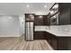 Modern kitchen featuring stainless steel appliances, dark cabinetry, and light countertops at 10184 Fire Skye Ave, Las Vegas, NV 89166