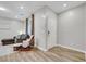 Comfortable living room with wood floors, a rocking chair, and neutral colors at 10184 Fire Skye Ave, Las Vegas, NV 89166