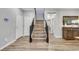 Elegant staircase with wood steps and dark railings, complemented by neutral walls and modern lighting at 10184 Fire Skye Ave, Las Vegas, NV 89166