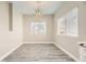 Dining room with a modern chandelier, wood floors, and natural light from the window at 1050 E Cactus Ave # 1049, Las Vegas, NV 89183