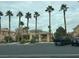 Charming exterior view of the building, complemented by lush palm trees and convenient parking at 1050 E Cactus Ave # 1049, Las Vegas, NV 89183