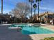 Sparkling pool with pristine blue water, surrounded by mature trees and well-kept landscaping at 1050 E Cactus Ave # 1049, Las Vegas, NV 89183