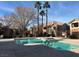 Resort-style pool featuring clear blue water, poolside lounge area, and palm tree accents at 1050 E Cactus Ave # 1049, Las Vegas, NV 89183