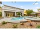 A backyard featuring a pool, patio, water feature, and desert landscaping at 10644 San Vercelli Ct, Las Vegas, NV 89141