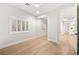 A brightly lit bedroom with a window, ceiling fan, and large closet with reflective doors at 10644 San Vercelli Ct, Las Vegas, NV 89141