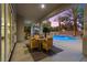 Elegant covered patio dining area overlooking pool, lush desert landscaping and covered gazebo at 10644 San Vercelli Ct, Las Vegas, NV 89141