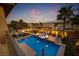 Aerial view of a backyard oasis with a pool, spa, and cozy lounge areas, set against a stunning desert backdrop at 12279 Lost Treasure Ave, Las Vegas, NV 89138