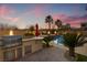 A luxury outdoor kitchen and pool provide the perfect space for entertaining or relaxing in style at 12279 Lost Treasure Ave, Las Vegas, NV 89138