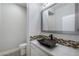 Bathroom vanity featuring gray stone counters, mosaic tile accents, and vessel sink at 12279 Lost Treasure Ave, Las Vegas, NV 89138