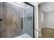 Modern bathroom features a frameless glass shower with sleek fixtures and gray tiling at 12279 Lost Treasure Ave, Las Vegas, NV 89138