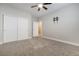 Bedroom with double closet, modern ceiling fan, and neutral carpeting at 12279 Lost Treasure Ave, Las Vegas, NV 89138